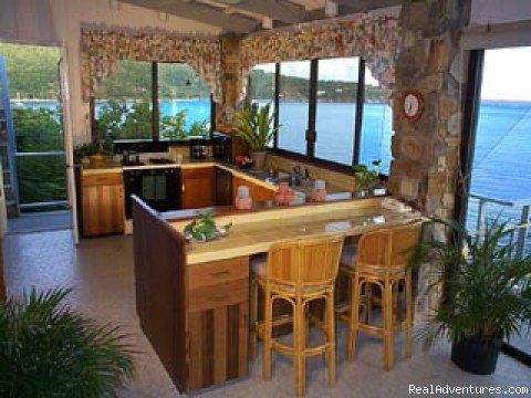 A spacious kitchen with pantry, bar and great water views