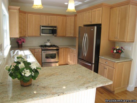 Designer kitchen with top appliances and granite countertops
