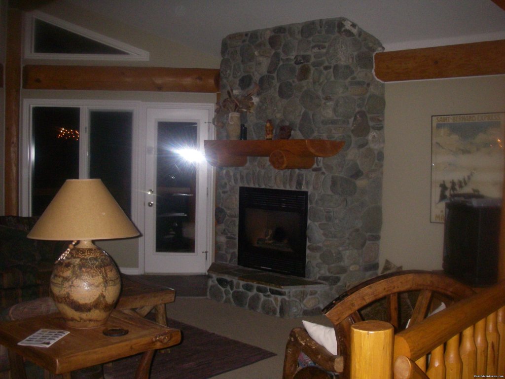 River rock fireplace. | Sun Peaks Resort Private Post &Beam Chalet | Image #15/23 | 