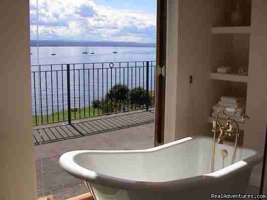 The bathroom in Bedroom 1 and French doors to terrace. | 5 star Water's Edge Bed and Breakfast in Scotland | Image #2/8 | 