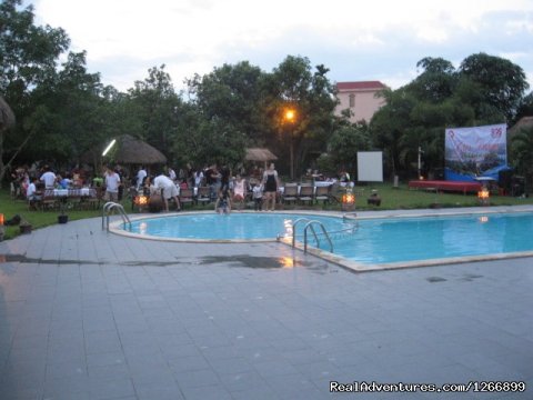 An evening  party on the grass near the swimming pool