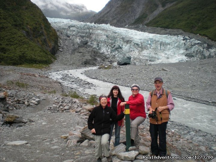 A group enjoys a photo in front of Fox Glacier | Self Drive and Guided New Zealand Tours | Image #13/19 | 