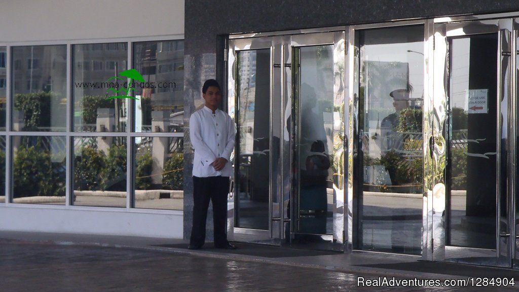 Friendly doorman receives guests | Manila Holiday Rentals at Sea Residences | Image #3/12 | 