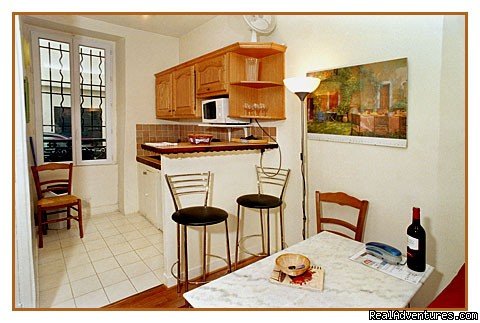 Eiffel studio table & kitchen area | Paris Studio Apartment Close to Eiffel Tower | Image #4/6 | 
