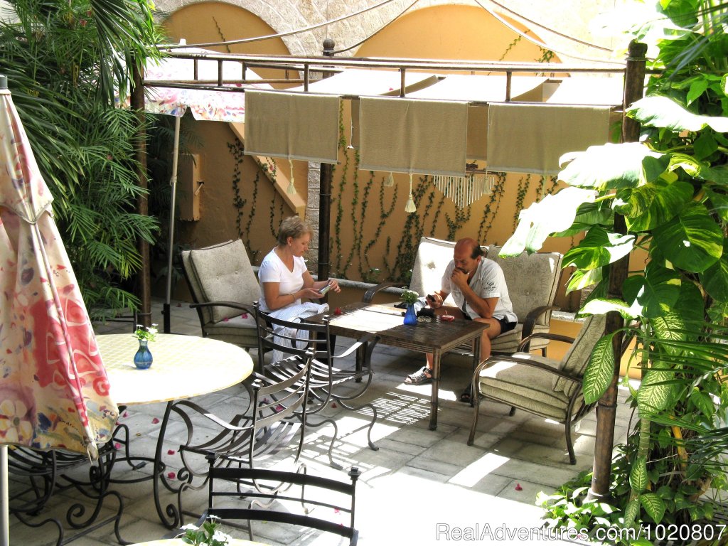 Guests relaxing at courtyard | CANCUN  INN, Suites   El Patio, Puerto Cancun | Image #4/10 | 
