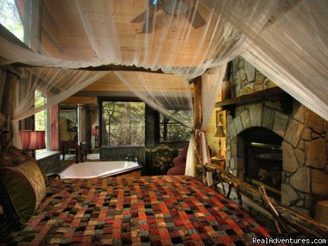 Romantic bedroom with fireplace and Jacuzzi (Slippery Rock) | Creekside luxury log cabins in the Smokies | Image #4/17 | 