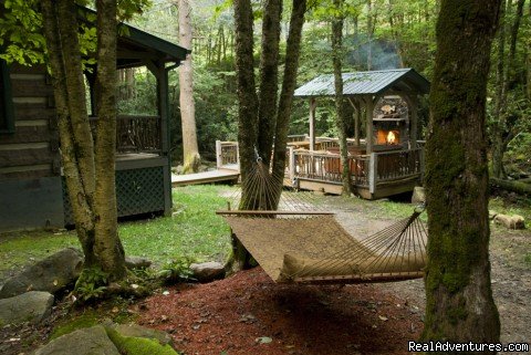 Creekside deck with fireplace and hot tub (Waters Edge) | Creekside luxury log cabins in the Smokies | Image #6/17 | 
