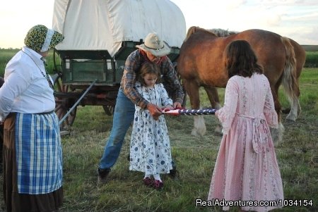 A Staff member teaches how to fold the Flag | Family Adventure on Genuine Covered Wagon Train | Image #7/13 | 