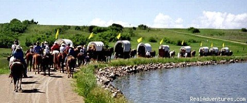 Covered Wagons travel around small lake