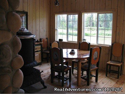 River front dining room with working pot belly stove | Image #9/12 | Deshka Wilderness Lodge
