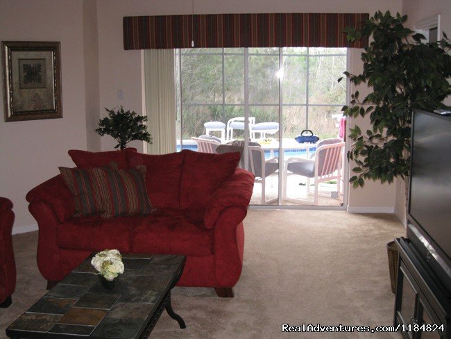 Living Room overlooks pool | Disney Vacation Pool Home -Backs onto Conservation | Image #11/13 | 