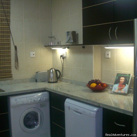 fully equipped kitchen with washing machine and microwave | Corner 1-bed apartment sea/Marina view in Dubai | Image #12/14 | 