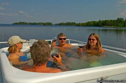 Nothing like a glass of wine, a hot tub, and good friends | Rainy Lake Houseboats  premier houseboat rentals | Image #6/8 | 