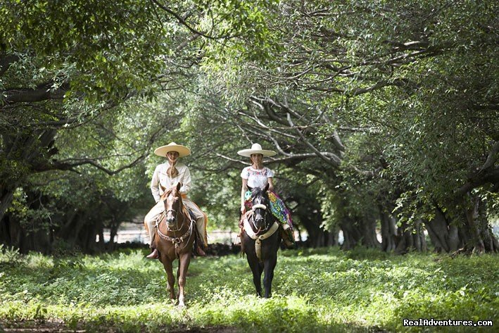 Mexican couple riding true the Lagos de Moreno ride | Horseback Riding Mexican Tours | Image #3/13 | 