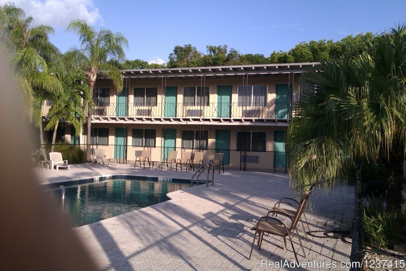 Caribbean style facing courtyard/pool | Rodeway Inn & Suites | Image #2/3 | 