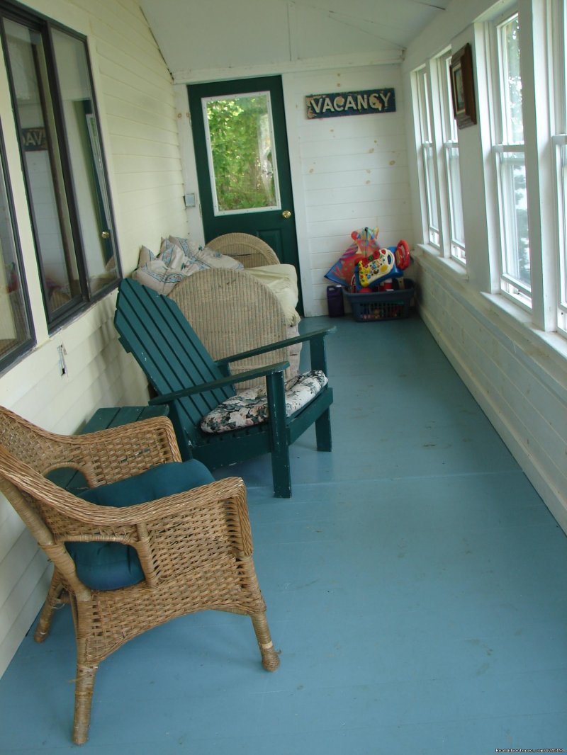 A porch with a grand view of Harmon's Harbor. | Quiet Maine Waterfront Cottage | Image #5/15 | 