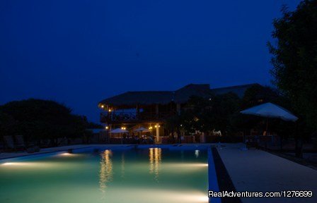 Night View of the main pavilion across the pool. | Hotel and Eco Resort with Beach chalets | Image #4/26 | 