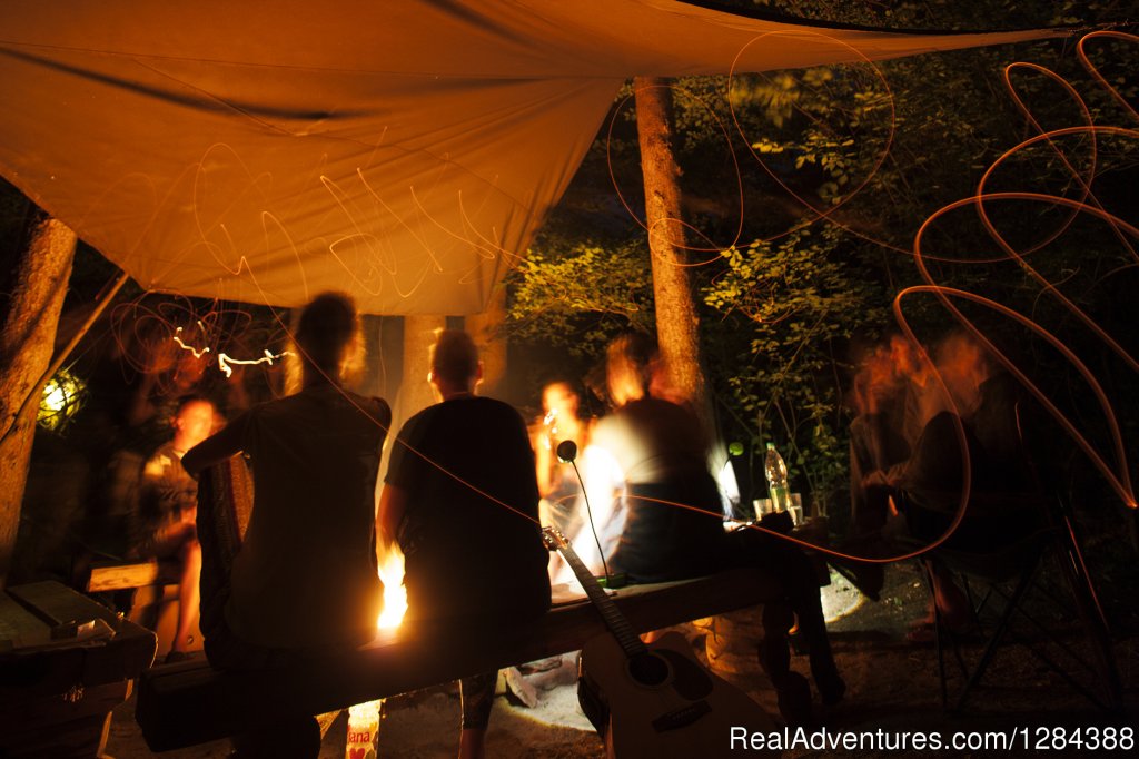 Guest evening socialising by the fireplace | Open air hostel NaturPlac | Image #10/26 | 