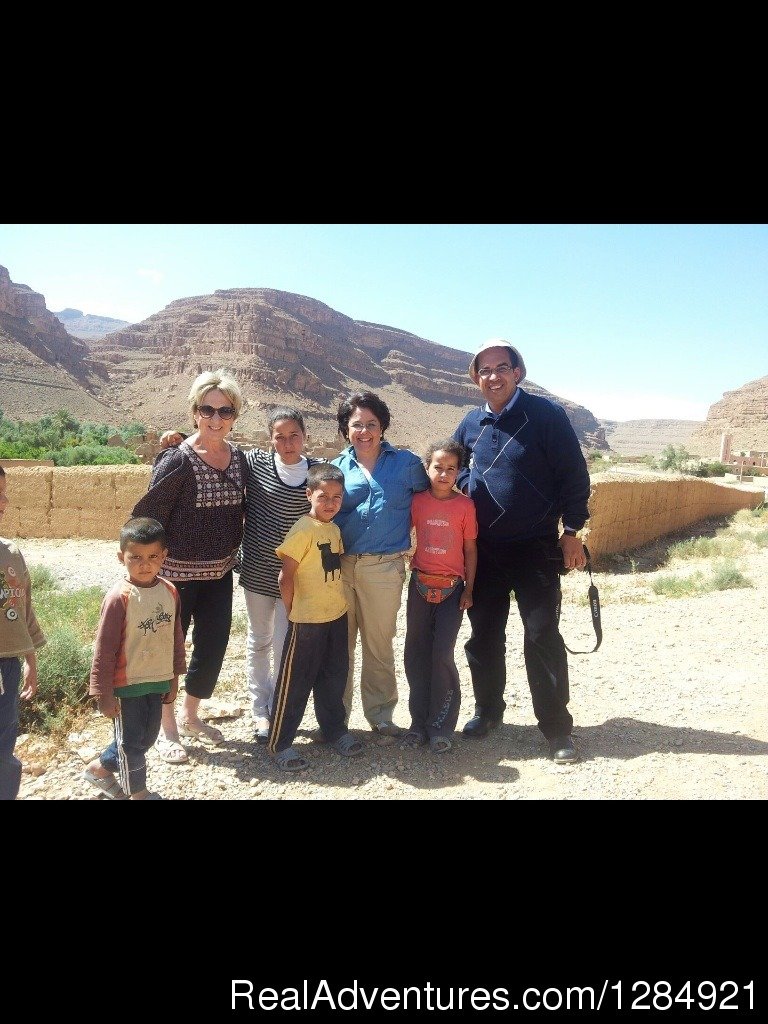 Hamid and his American clients with Berber kids | Enjoy a real adventure with a Moroccan tour guide | Image #5/16 | 